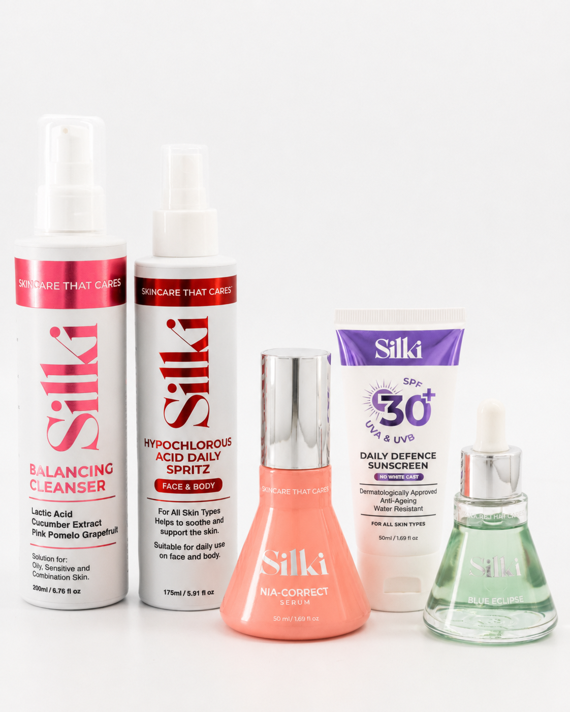 A group of five Silki skincare products formulated for oily and breakoutprone skin, arranged on a plain white background, including a balancing cleanser, a hypochlorous acid daily spritz, Nia-Correct Niacinamide serum, SPF30 daily defence sunscreen and Blue Eclipse